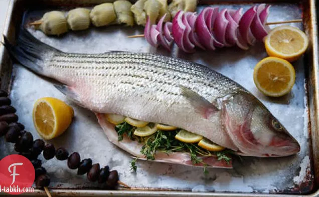 باس كامل مشوي مع الزيتون والبصل والخرشوف